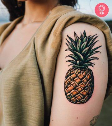 A pineapple tattoo on the upper arm A pineapple tattoo on the upper arm
