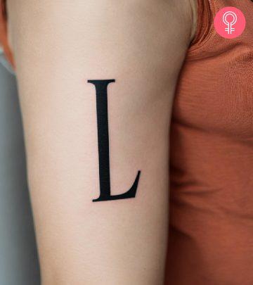 Woman with L initial tattoo on her arm Woman with L initial tattoo on her arm
