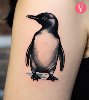 A cute penguin tattoo on the upper arm A cute penguin tattoo on the upper arm