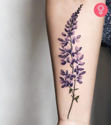 A wisteria tattoo on the arm of a woman A wisteria tattoo on the arm of a woman
