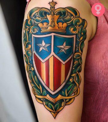 A woman flaunting a shield tattoo on the upper arm A woman flaunting a shield tattoo on the upper arm