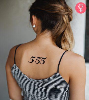 A woman with a 555 tattoo on her upper back A woman with a 555 tattoo on her upper back