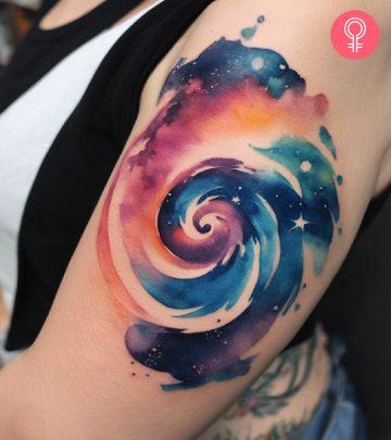 A swirl tattoo on the upper arm of a woman A swirl tattoo on the upper arm of a woman
