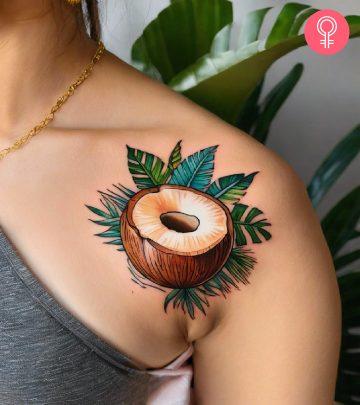 A woman flaunting a coconut tattoo on her shoulder A woman flaunting a coconut tattoo on her shoulder