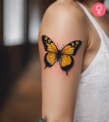 Yellow butterfly tattoo on the arm of a woman Yellow butterfly tattoo on the arm of a woman