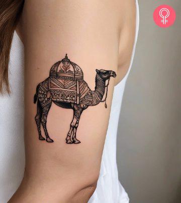 Woman with a camel tattoo on the upper arm Woman with a camel tattoo on the upper arm