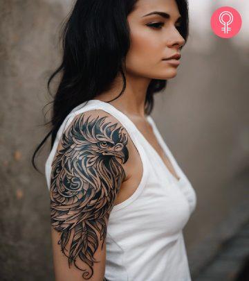 A griffin head tattoo on a woman’s upper arm A griffin head tattoo on a woman’s upper arm