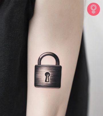 Woman with lock tattoo on her arm Woman with lock tattoo on her arm