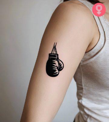 A woman with a boxing gloves tattoo on her arm A woman with a boxing gloves tattoo on her arm