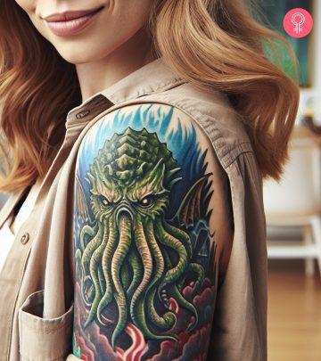 A Cthulhu tattoo on a woman’s upper arm A Cthulhu tattoo on a woman’s upper arm