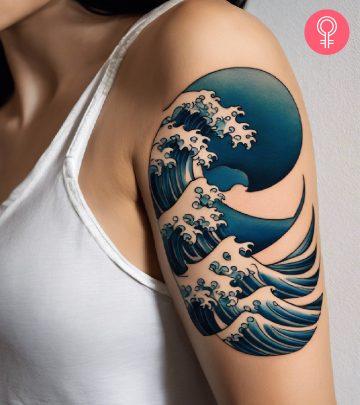 A Japanese wave tattoo on the upper arm of a woman A Japanese wave tattoo on the upper arm of a woman