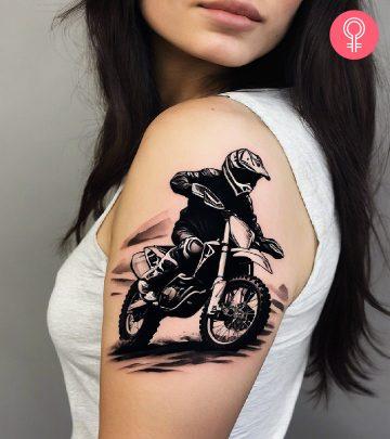 A blackwork tattoo of a motocross racer on a woman’s upper arm A blackwork tattoo of a motocross racer on a woman’s upper arm