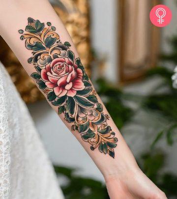 A colorful baroque tattoo with roses and leaves on the forearm A colorful baroque tattoo with roses and leaves on the forearm