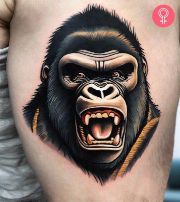 A man wearing a traditional King Kong tattoo on the upper arm. A man wearing a traditional King Kong tattoo on the upper arm.