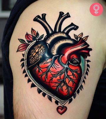 A man wearing a traditional anatomical heart tattoo on the upper arm A man wearing a traditional anatomical heart tattoo on the upper arm