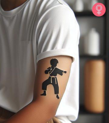 A man with a karate kid tattoo on the upper arm A man with a karate kid tattoo on the upper arm
