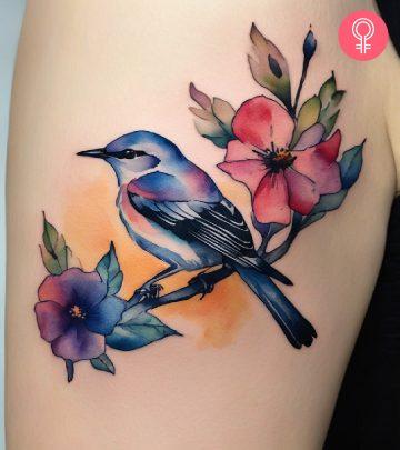 A mockingbird tattoo on a woman’s upper arm A mockingbird tattoo on a woman’s upper arm