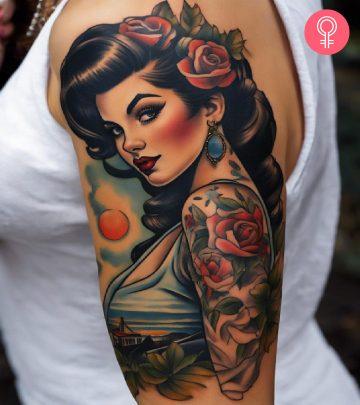A pin-up girl tattoo on a woman’s upper arm A pin-up girl tattoo on a woman’s upper arm
