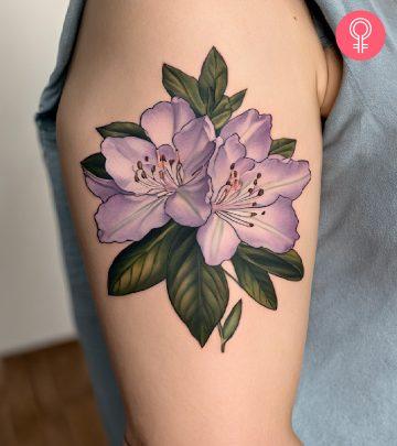 A purple rhododendron tattoo on the upper arm A purple rhododendron tattoo on the upper arm
