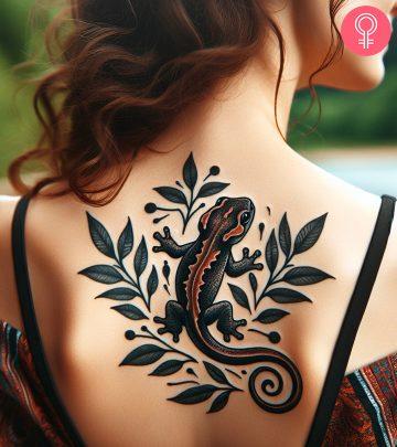 A salamander tattoo on the upper back of a woman A salamander tattoo on the upper back of a woman