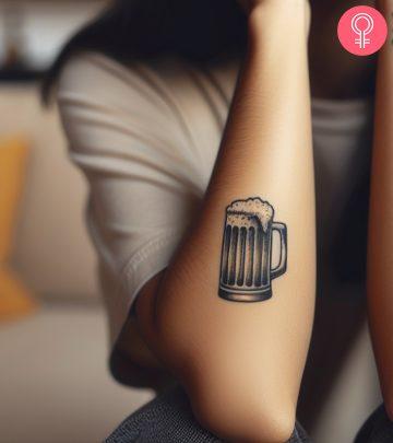 A woman with a beer tattoo on her arm A woman with a beer tattoo on her arm