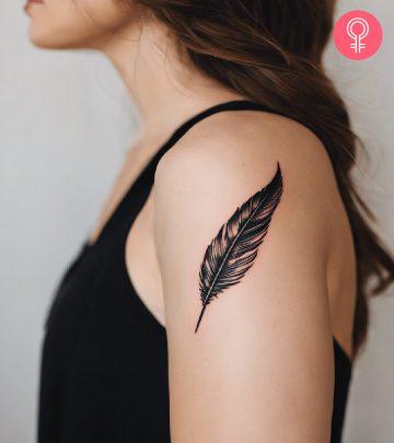 A woman with a black quill tattoo on her upper arm A woman with a black quill tattoo on her upper arm