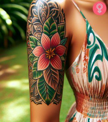 A woman with a floral Fijian tattoo on her upper arm A woman with a floral Fijian tattoo on her upper arm