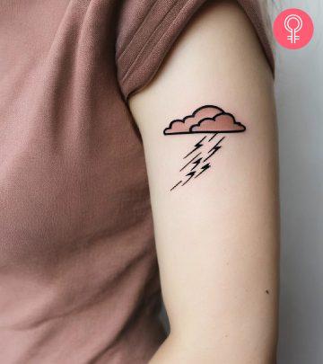 A woman with a thunderstorm tattoo on her upper arm A woman with a thunderstorm tattoo on her upper arm