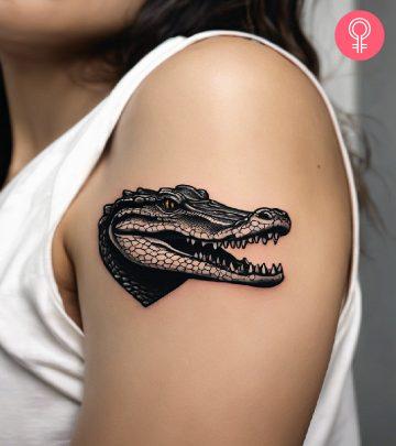 Alligator tattoo on the upper arm Alligator tattoo on the upper arm