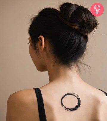 An enso circle tattoo on the back of a woman’s neck An enso circle tattoo on the back of a woman’s neck