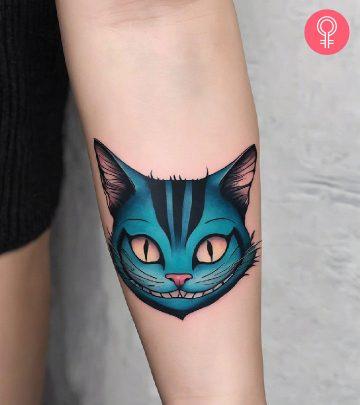 Cheshire cat tattoo on the upper arm Cheshire cat tattoo on the upper arm