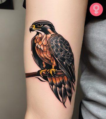 Woman with a falcon tattoo on her arm Woman with a falcon tattoo on her arm
