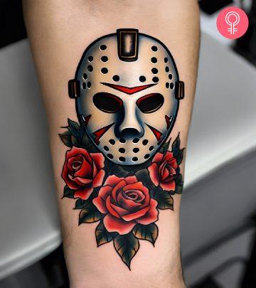 A traditional Jason mask tattoo with roses inked on the forearm A traditional Jason mask tattoo with roses inked on the forearm