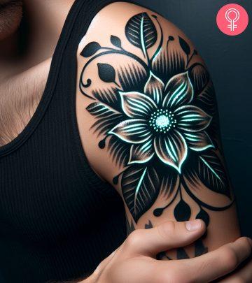 A man wearing an invisible glow in the dark tattoo on the upper arm. A man wearing an invisible glow in the dark tattoo on the upper arm.