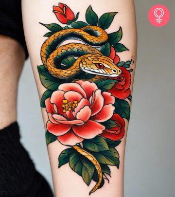 A serpent tattoo on the forearm with flowers A serpent tattoo on the forearm with flowers