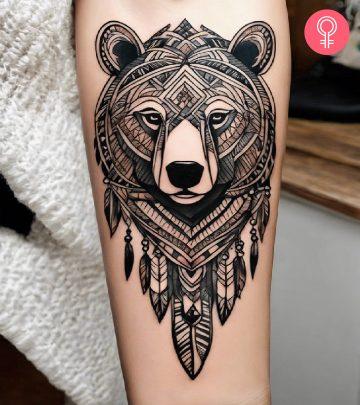 A tribal bear tattoo inked on the forearm A tribal bear tattoo inked on the forearm