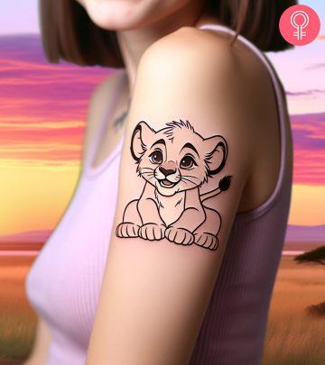 Woman with Simba tattoo on her wrist Woman with Simba tattoo on her wrist
